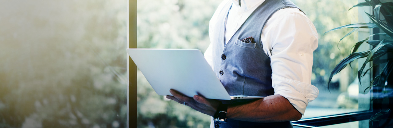 Investor carrying laptop