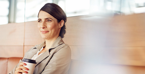 Woman investor relaxing with coffee